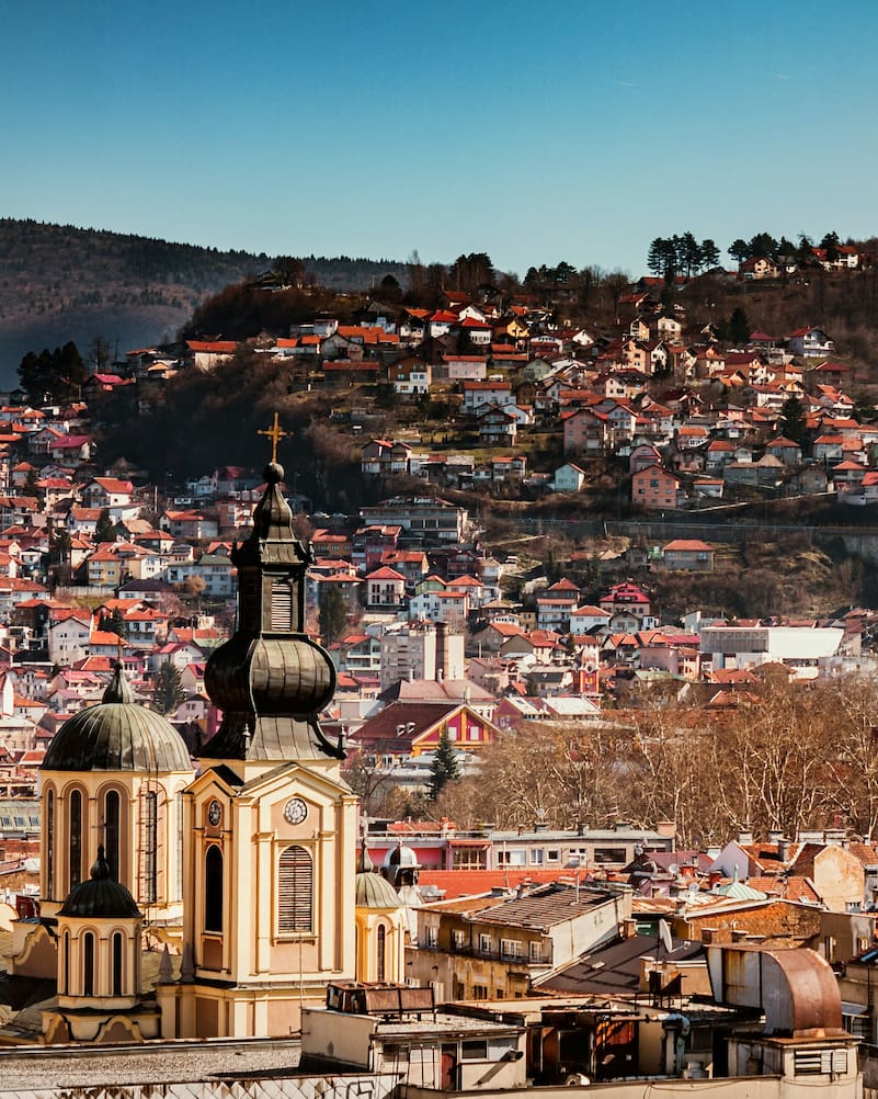 Cityscape of Sarajevo with Orthodox cathedral and traditional houses on a hill in Bosnia and Herzegovina.